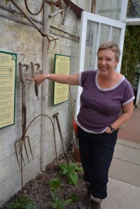 Emma Davies with a fork marked with Charles Gunther's initials - he owned the estate when most of the glasshouses were built